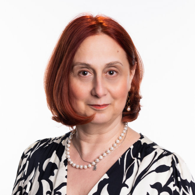 Dr. Falu smiling in a colorful pediatric office